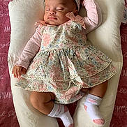 Amiylah is registered to the contest to win money with this photo: baby, sleeping, floral_dress, headband, cushion, blanket, pink, white, socks, infant, resting, cute, peaceful, portrait, child, soft, indoors, comfort, toddler, adorable