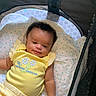 Amiylah is registered to the contest to win money with this photo: arm, baby, bear_faces, blanket, child, cute, face, happy, head, indoor, infant, infant_clothing, patterned_blanket, person, playpen, polka_dots, resting, smiling, striped_pants, yellow_clothing