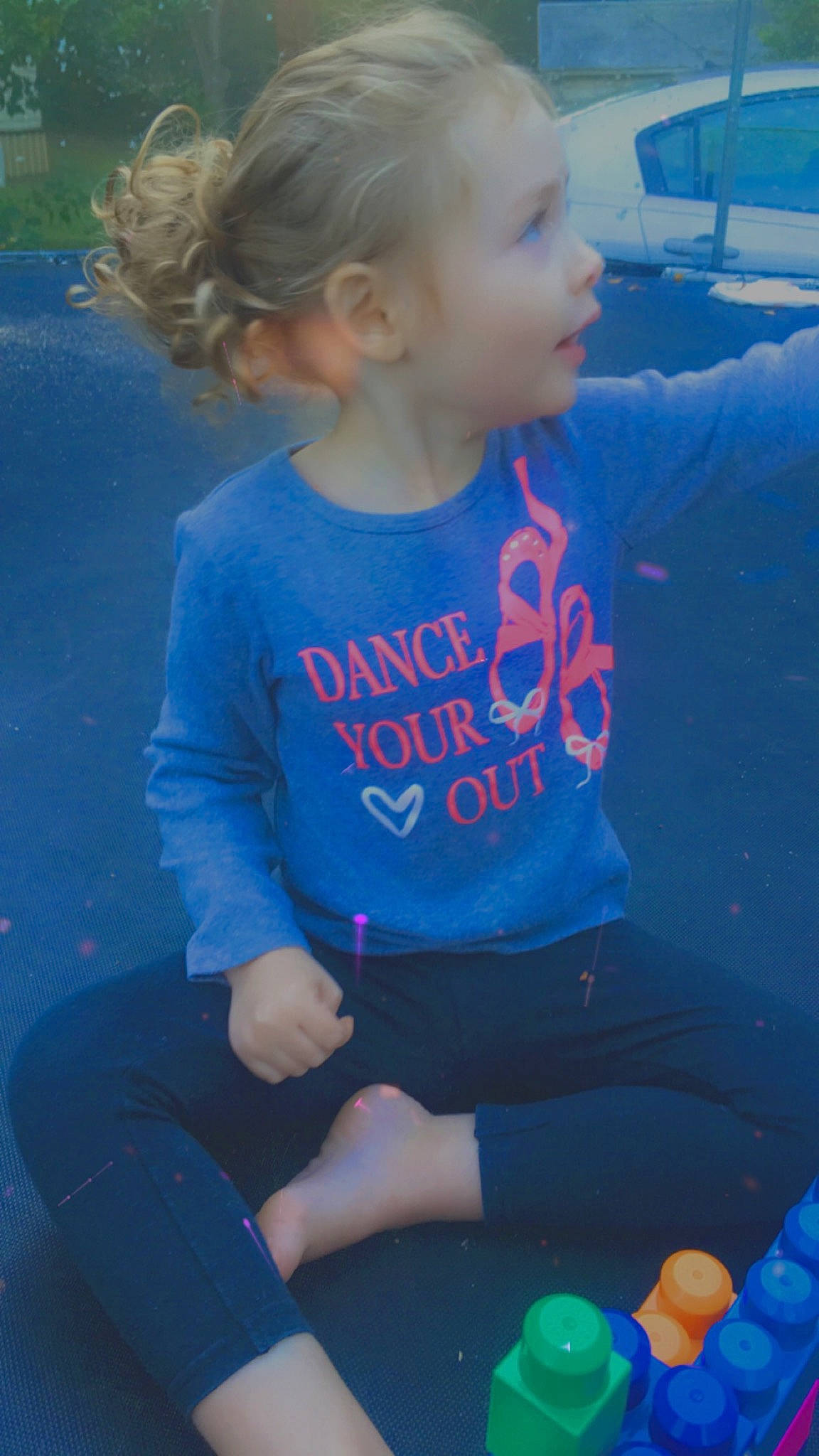 Rebecca is registered to the contest to win money with this photo: automotive_exterior, baby_toddler_clothing, blond, blue, child, ear, electric_blue, human_body, knee, lap, majorelle_blue, mouth, party_supply, person, play, sitting, sock, summer, toddler, toy