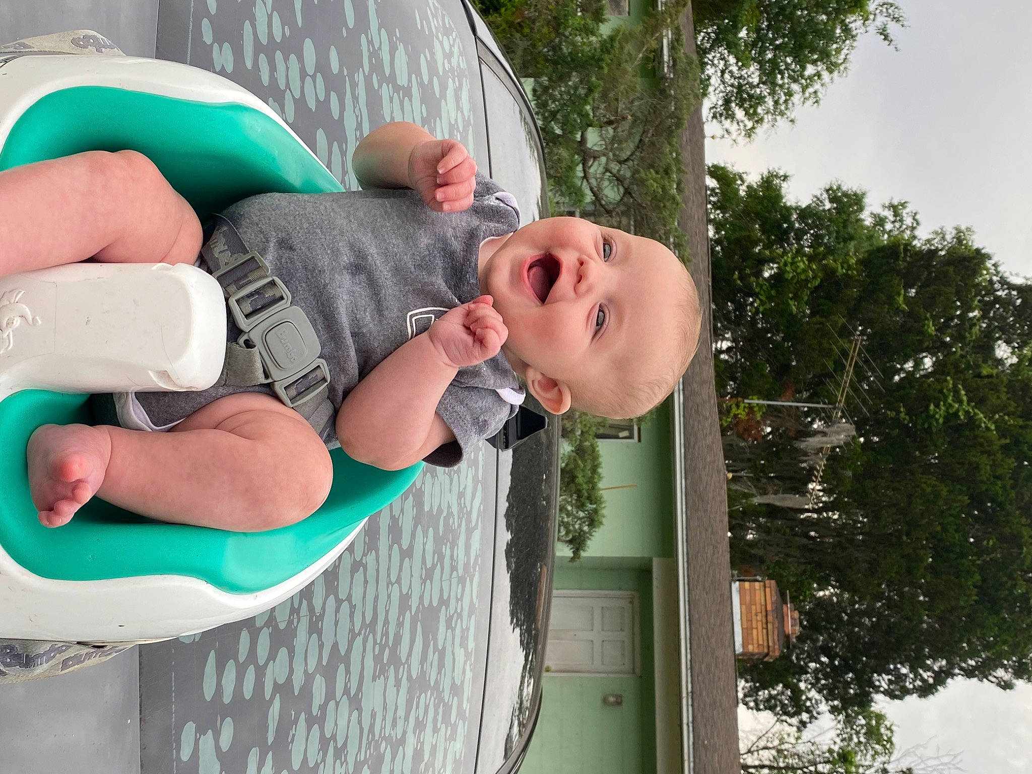 Braylen is registered to the contest to win money with this photo: baby, child, comfort, elbow, facial_expression, fun, grass, green, happy, leisure, person, play, recreation, sky, smile, toddler, tree, vacation, water
