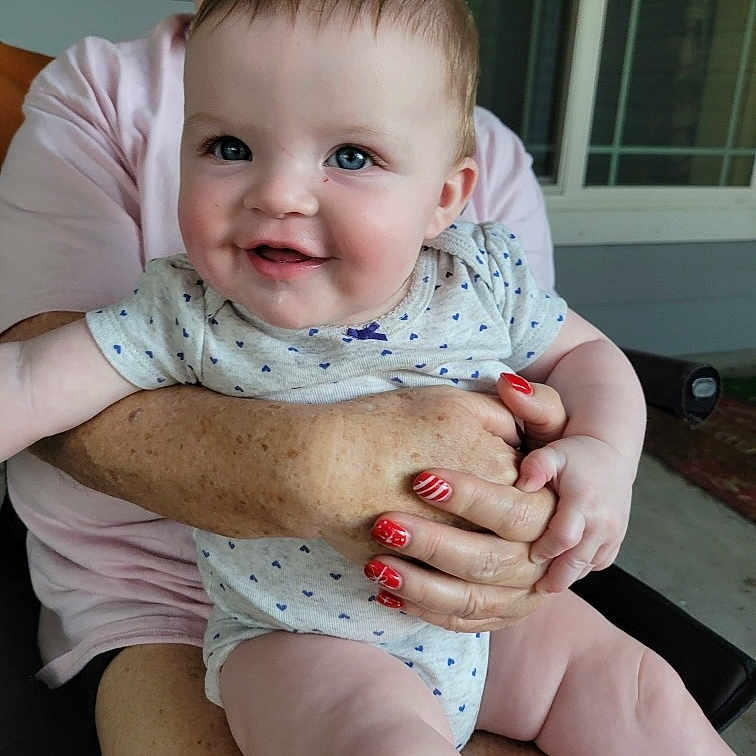 Elliana joined the competition — help win amazing prizes! accessories, baby, bodypart, chair, clothing, couch, face, finger, furniture, hand, happy, head, jewelry, laughing, person, photography, portrait, ring, sitting, t_shirt