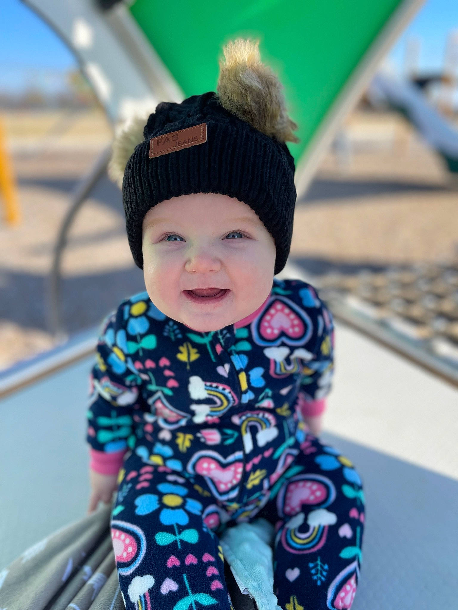 Sadie is registered to the contest to win money with this photo: baby, baby_toddler_clothing, cap, child, eye, face, fun, green, happy, hat, headgear, headwear, human_body, leisure, outerwear, person, photograph, product, skin, sleeve