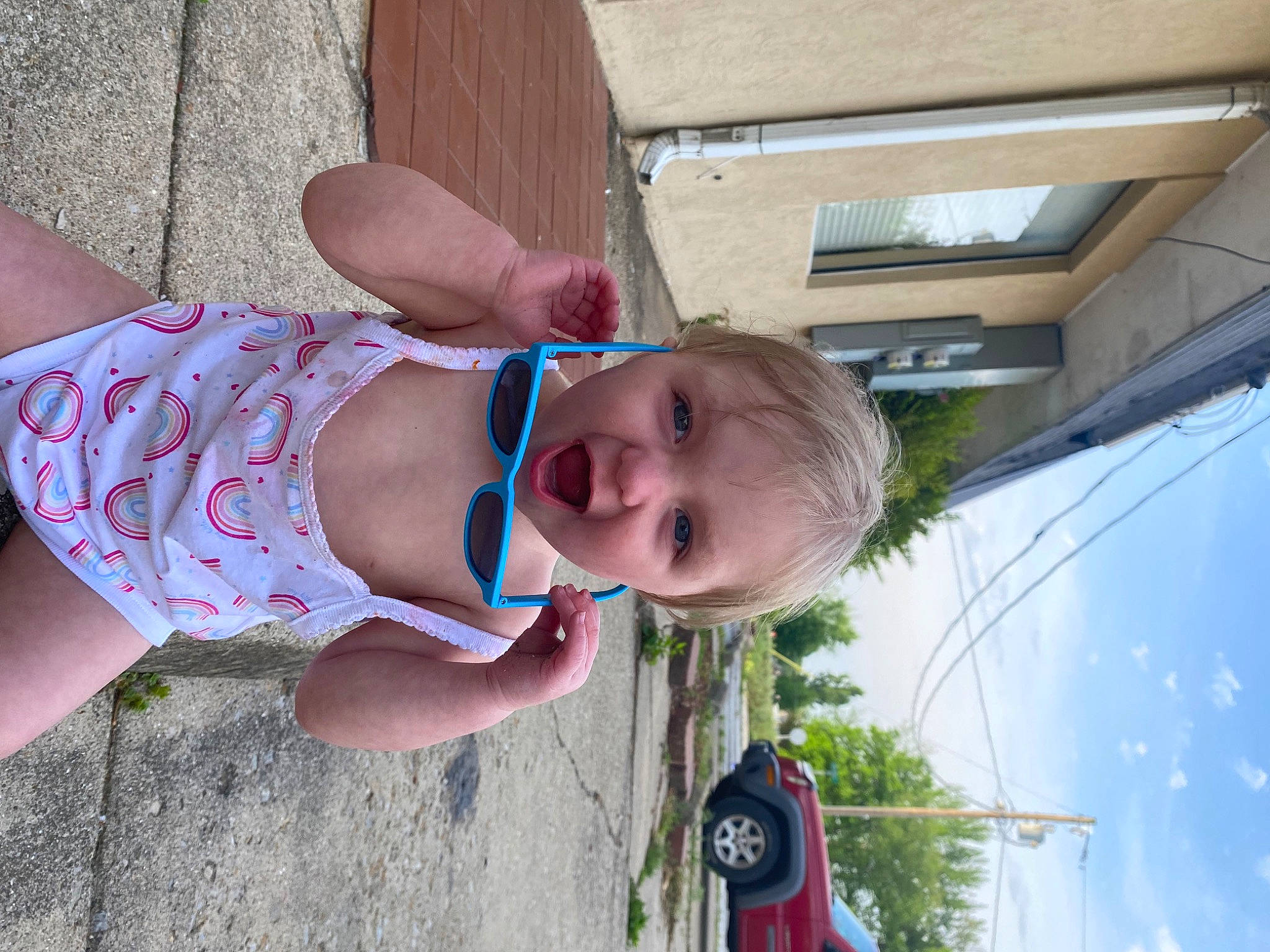 Rhaenyra joined the competition — help win amazing prizes! baby, car, child, eyewear, foot, fun, grass, happy, human_leg, leisure, person, skin, sky, smile, sunglasses, thigh, toddler, tree, trunk, vehicle_door