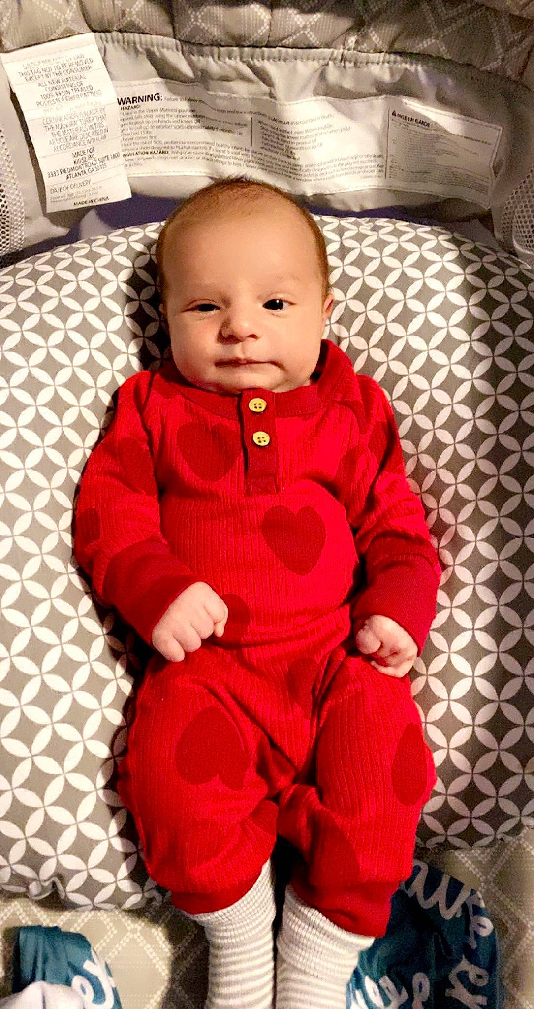 Lawrence is registered to the contest to win money with this photo: baby, baby_toddler_clothing, cheek, comfort, dress, eye, face, floor, flooring, happy, head, human_body, iris, lip, person, skin, sleeve, smile, textile, toddler