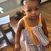 Brenlee joined the competition — help win amazing prizes! toddler, child, indoor, person, hair_clips, striped_clothing, colorful_outfit, wooden_floor, furniture, window, curious_expression, young_child, casual_wear, brown_skin, short_hair, standing, natural_light, room, floor, toy