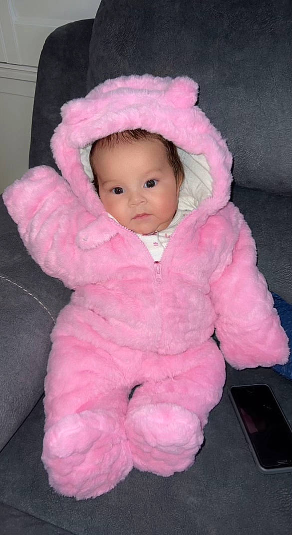 Aaliyah is registered to the contest to win money with this photo: baby, baby_toddler_clothing, cheek, child, comfort, eye, fur, hood, hoodie, iris, jacket, linens, lip, magenta, nose, person, pink, skin, sleeve, toddler