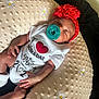 Jahmira joined the competition — help win amazing prizes! baby, closeup, clothing, comfort, cute, embroidered, flower, hand, headband, indoor, infant, love_message, newborn, onesie, pacifier, person, pillow, resting, sleeping, soft_texture