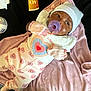Jahmira is registered to the contest to win money with this photo: baby, baby_care, beanie, blanket, child, clothing, comfort, cute, fabric, face, heart_pattern, infant, lying_down, mittens, newborn, pacifier, pink, sleepwear, soft, tube