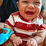 baby, smiling, happy, infant, toy, striped_clothing, sitting, barefoot, indoor, person, cute, chubby_cheeks, closeup, child, young, skin, fingers, feet, adult_in_background, red