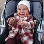 baby, smiling, plaid_jacket, white_hat, car_seat, child, happy, clapping_hands, cute, infant, outdoor, clothing, seat, portrait, joy, warm, babywear, kid, person, expression