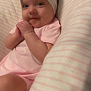 Nova joined the competition — help win amazing prizes! baby, bow, child, cozy, cushion, cute, face, hands, happy, headband, indoors, infant, pink_clothing, portrait, resting, skin, smile, soft_lighting, striped, toddler