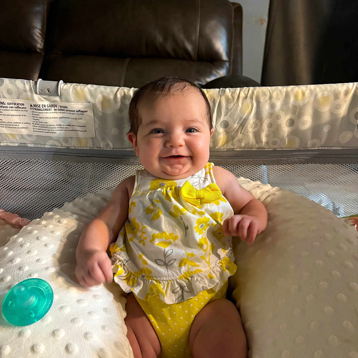 Adeline joined the competition — help win amazing prizes! baby, baby_seat, child, comfort, curtain, cushion, cute, floral_pattern, happy, home, indoor, infant, leather_couch, pacifier, person, portrait, seated, smiling, soft_texture, yellow_clothing