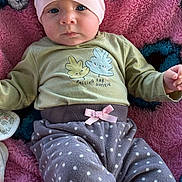 Oaklynn is registered to the contest to win money with this photo: baby, infant, child, beanie, blue_eyes, pink_beanie, polka_dot_pants, cozy_clothes, blanket, soft_texture, cute, portrait, indoors, lying_down, small_hands, expression, casual_wear, baby_clothes, pink, blue