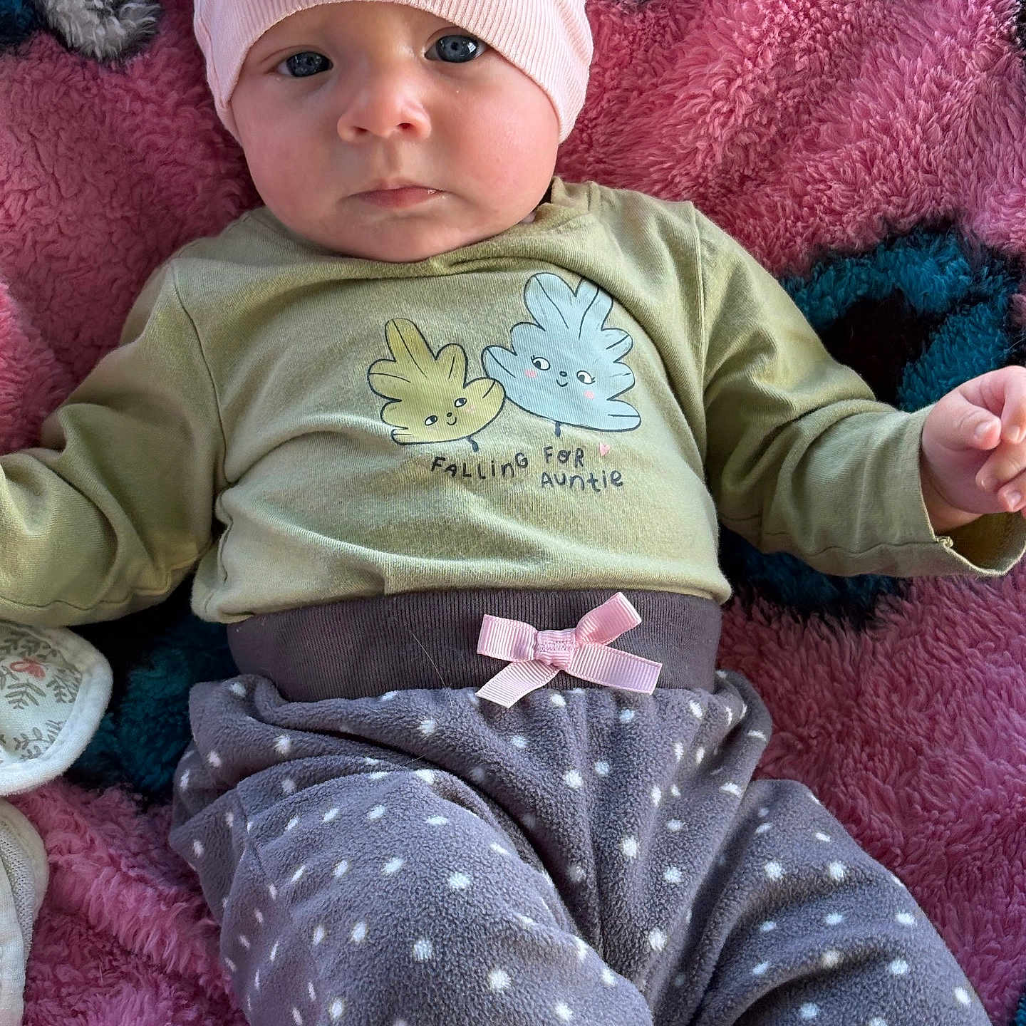 Oaklynn is registered to the contest to win money with this photo: baby, infant, child, beanie, blue_eyes, pink_beanie, polka_dot_pants, cozy_clothes, blanket, soft_texture, cute, portrait, indoors, lying_down, small_hands, expression, casual_wear, baby_clothes, pink, blue