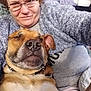 Bruno joined the competition — help win amazing prizes! person, dog, glasses, smile, winking, cozy, indoor, sweater, blanket, pet, snuggle, relaxed, face, portrait, casual, collar, brown_dog, furniture, home, comfort