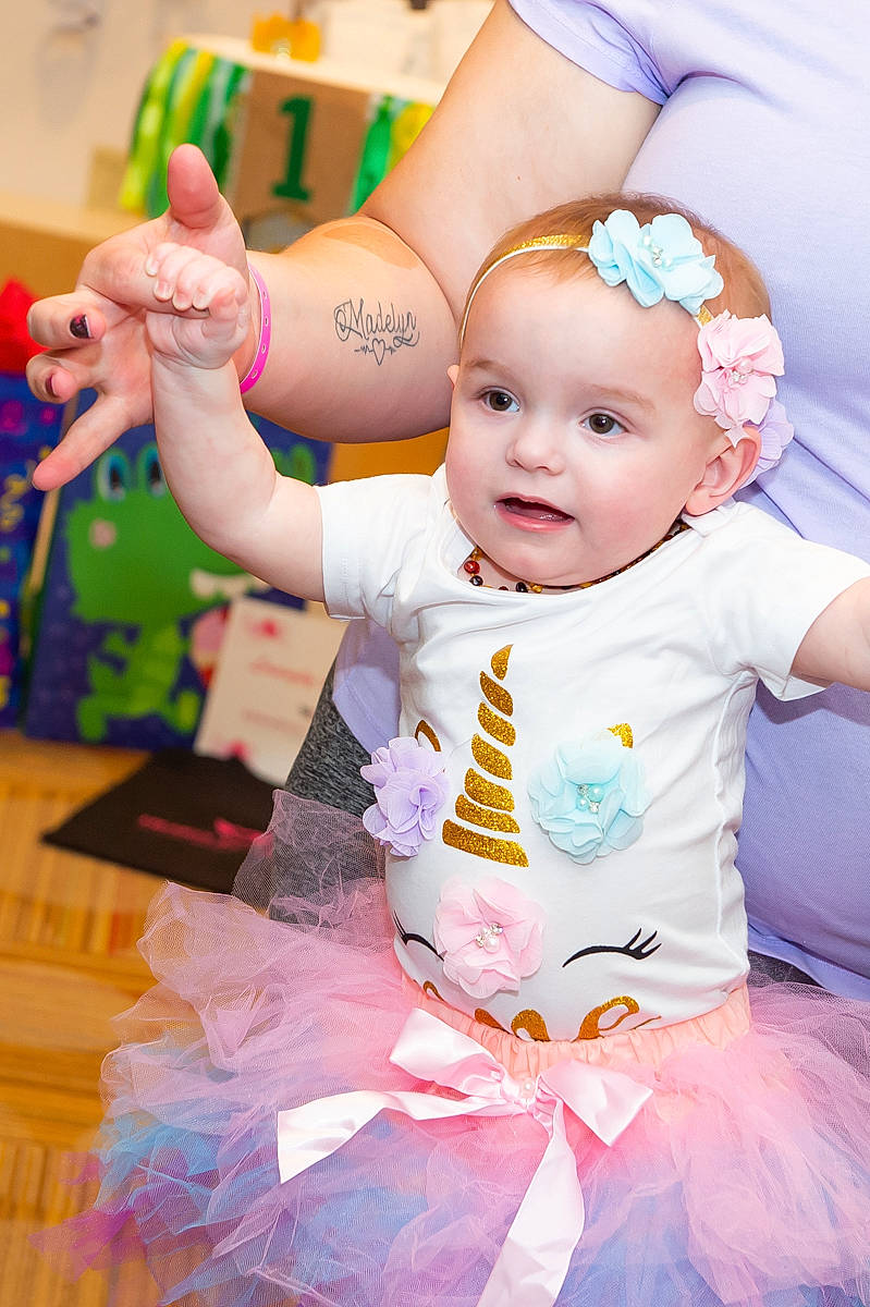 Kayla is registered to the contest to win money with this photo: baby, baby_toddler_clothing, child, event, fun, green, hand, happy, hat, jewellery, leisure, party_supply, people, person, photograph, pink, purple, smile, toddler, white