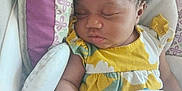 Skylar is registered to the contest to win money with this photo: baby, sleeping, infant, child, blanket, cushion, clothing, curly_hair, face, peaceful, resting, seat, soft, indoors, cute, young, comfort, toddler, pattern, portrait