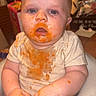 baby, messy, food, high_chair, orange, face, hands, clothing, indoor, curious, blue_eyes, sitting, child, stain, infant, cute, skin, expression, person, young