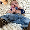 baby, infant, blue_eyes, bow_tie, jeans, knit_blanket, indoor, cute, child, wristband, star_pattern, denim, portrait, casual, relaxed, small_person, clothing, face, sitting, home
