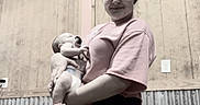 Jayce joined the competition — help win amazing prizes! woman, baby, indoor, wooden_wall, metal_panel, pink_shirt, black_skirt, holding, smiling, child, person, portrait, text_overlay, motivational_text, floor, window, power_outlet, light_skin, short_hair, casual_clothing