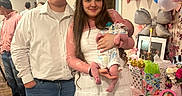 Jayce is registered to the contest to win money with this photo: baby, balloons, celebration, couple, decorations, family, female, gift_bags, indoor, jeans, male, newborn, pacifier, party, people, photo_frames, smile, standing, white_dress, wooden_floor