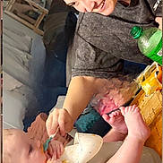 Jayce joined the competition — help win amazing prizes! baby, feeding, high_chair, woman, smiling, indoor, table, bottle, bib, happy, face, person, home, furniture, casual, skin, hand, foot, clothing, interaction