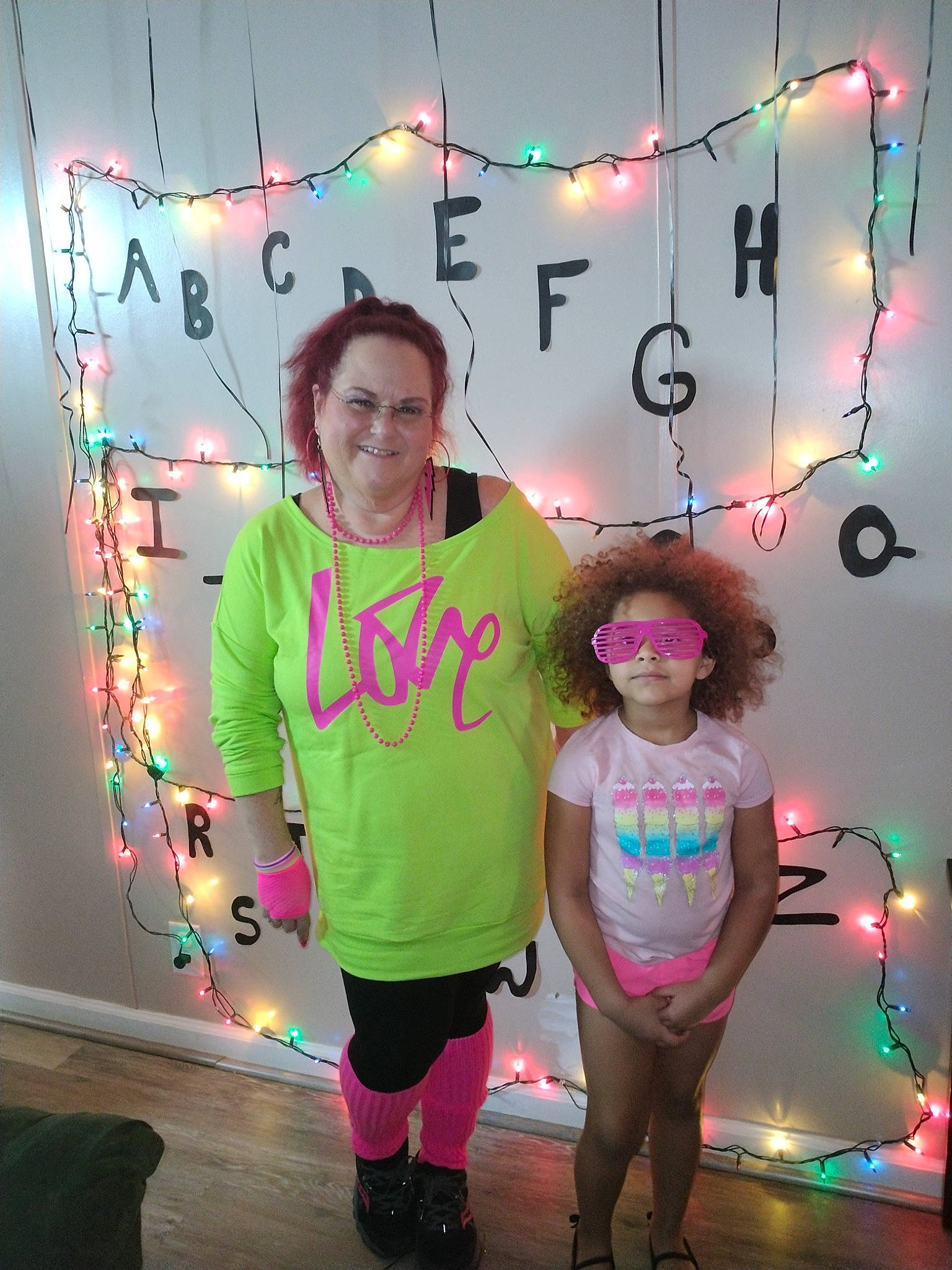 Janiah is registered to the contest to win money with this photo: art, child, electricity, entertainment, event, eyewear, fashion_design, fun, happy, joy, leisure, light, lighting, magenta, necklace, party_supply, person, pink, purple, shorts