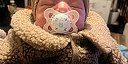 Gweni joined the competition — help win amazing prizes! baby, child, pacifier, head_wrap, bow, sleeping, cozy, jacket, indoor, blurred_background, soft_lighting, face, clothing, toddler, closeup, warm, cute, infant, bundle, peaceful