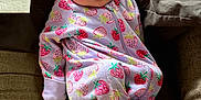 Kinleigh joined the competition — help win amazing prizes! baby, newborn, sleeping, onesie, strawberry_pattern, couch, cozy, infant, child, cute, soft_lighting, indoor, fabric, comfort, relaxation, portrait, clothing, peaceful, small, person