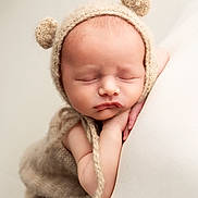 Carter-Blu joined the competition — help win amazing prizes! baby, newborn, sleeping, knitted_hat, bear_ears, blanket, soft_texture, neutral_colors, closeup, peaceful, infant, cute, child, portrait, resting, cozy, warm, hands, face, skin