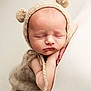baby, newborn, sleeping, knitted_hat, bear_ears, blanket, soft_texture, neutral_colors, closeup, peaceful, infant, cute, child, portrait, resting, cozy, warm, hands, face, skin