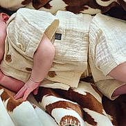 Declan is registered to the contest to win money with this photo: baby, sleeping, blanket, infant, cozy, clothing, soft, peaceful, cute, newborn, skin, hand, foot, rest, comfort, portrait, lying_down, indoors, warm, toddler