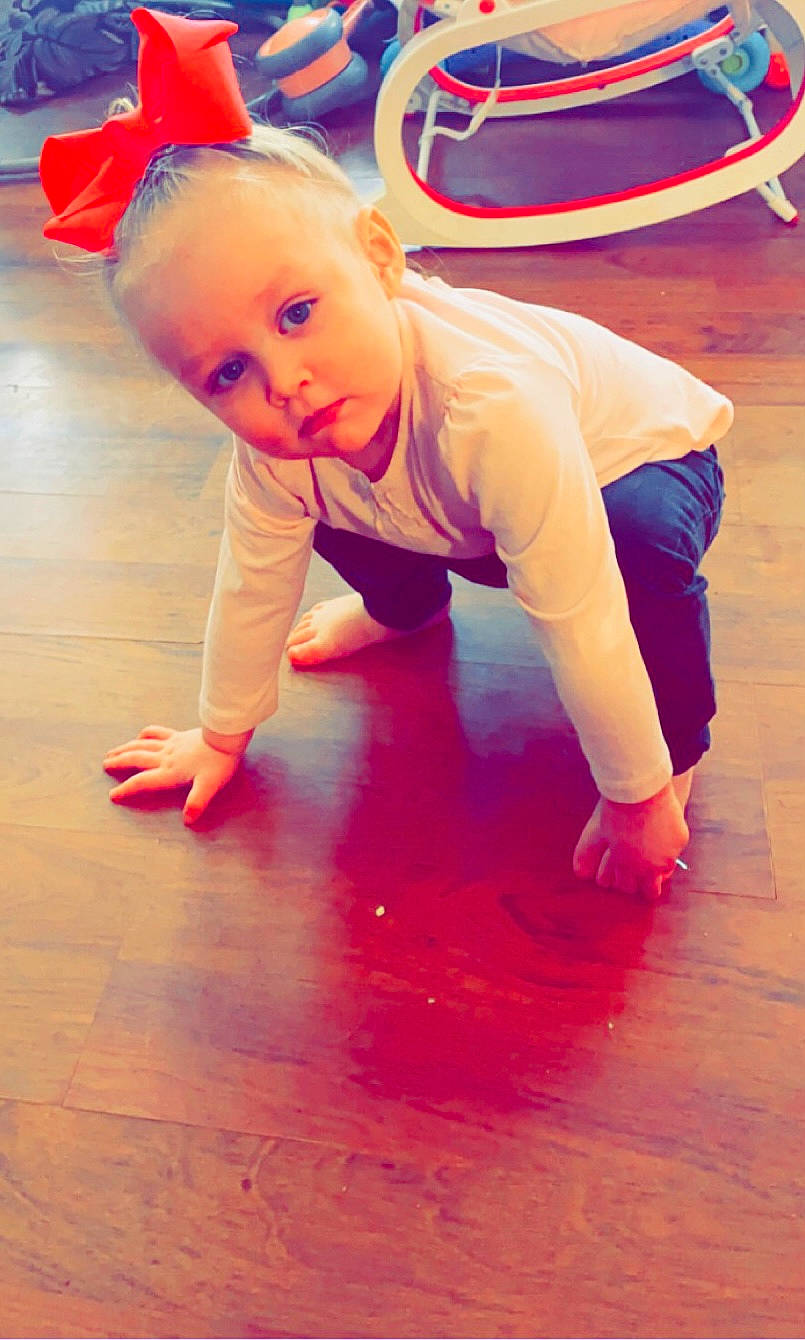 Fallon is registered to the contest to win money with this photo: baby_toddler_clothing, crawling, entertainment, floor, flooring, fun, happy, hardwood, joint, knee, leg, magenta, orange, performing_arts, person, pink, sleeve, sportswear, t_shirt, toddler