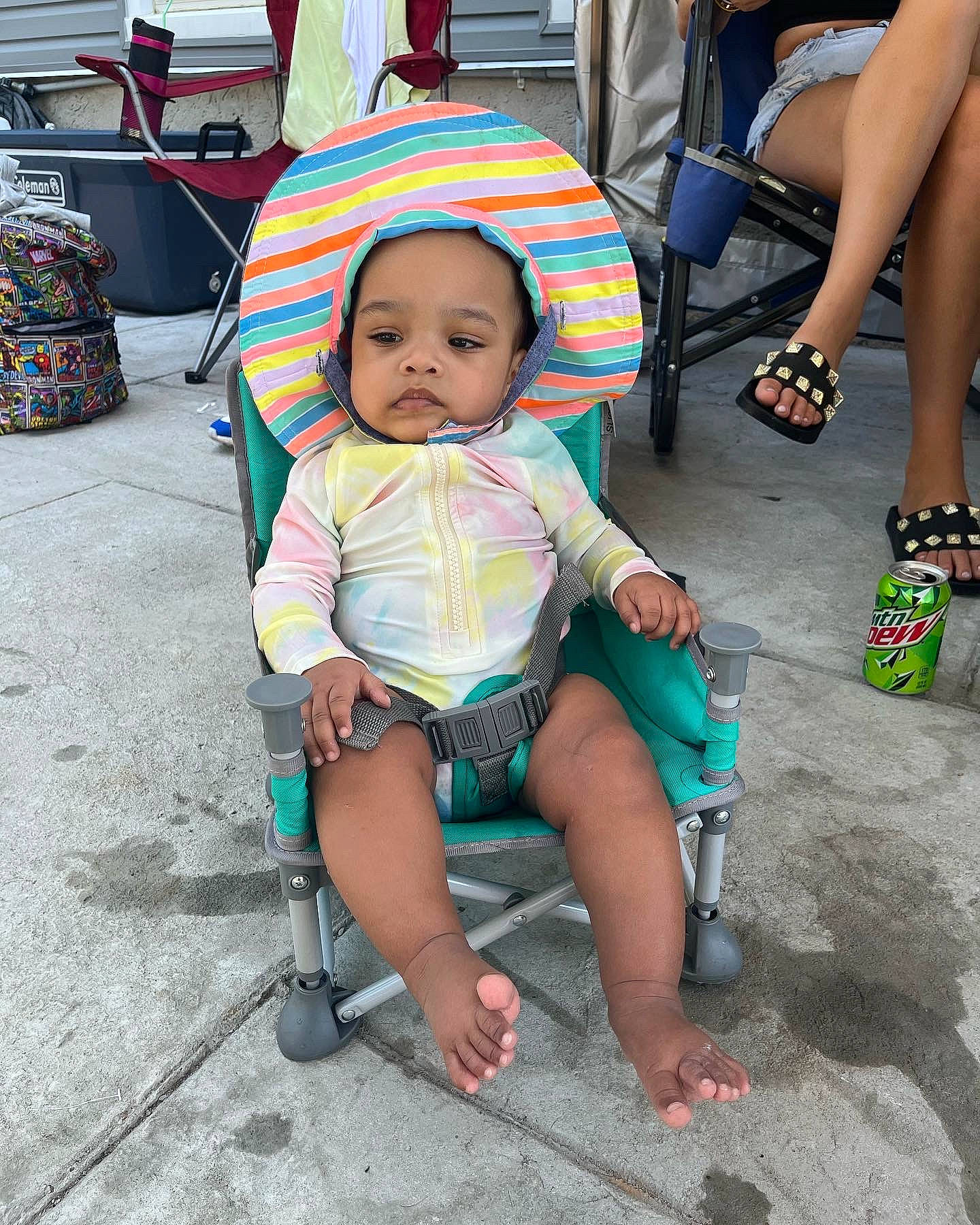 Dyonnah joined the competition — help win amazing prizes! baby, baby_toddler_clothing, child, eyewear, flip_flops, foot, fun, hat, human_leg, leg, leisure, person, recreation, sandal, shoe, shorts, sidewalk, sitting, sneakers, thigh