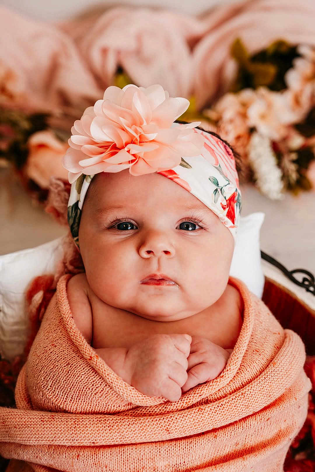 Starla joined the competition — help win amazing prizes! baby, infant, wrapped, blanket, headband, flower, pink, cute, portrait, face, skin, hands, newborn, soft, warm, cozy, closeup, child, eyes, indoor