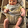 baby, infant, bouncer, babybjorn, bib, yellow_clothing, smile, happy, cute, indoors, carpet, wooden_floor, baby_seat, child, person, legs, arms, face, skin, comfort