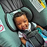 Christian joined the competition — help win amazing prizes! baby, car_seat, child, smiling, face, curly_hair, clothing, seatbelt, safety, indoor, pacifier, infant, cute, happy, person, gloves, fabric, headrest, portrait, toddler