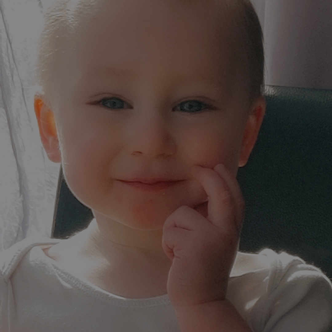 Peter-Junior is registered to the contest to win money with this photo: baby, bodypart, couch, ear, face, finger, frown, furniture, hand, happy, head, mouth, newborn, person, photography, portrait, sad, sitting, smile, wrist