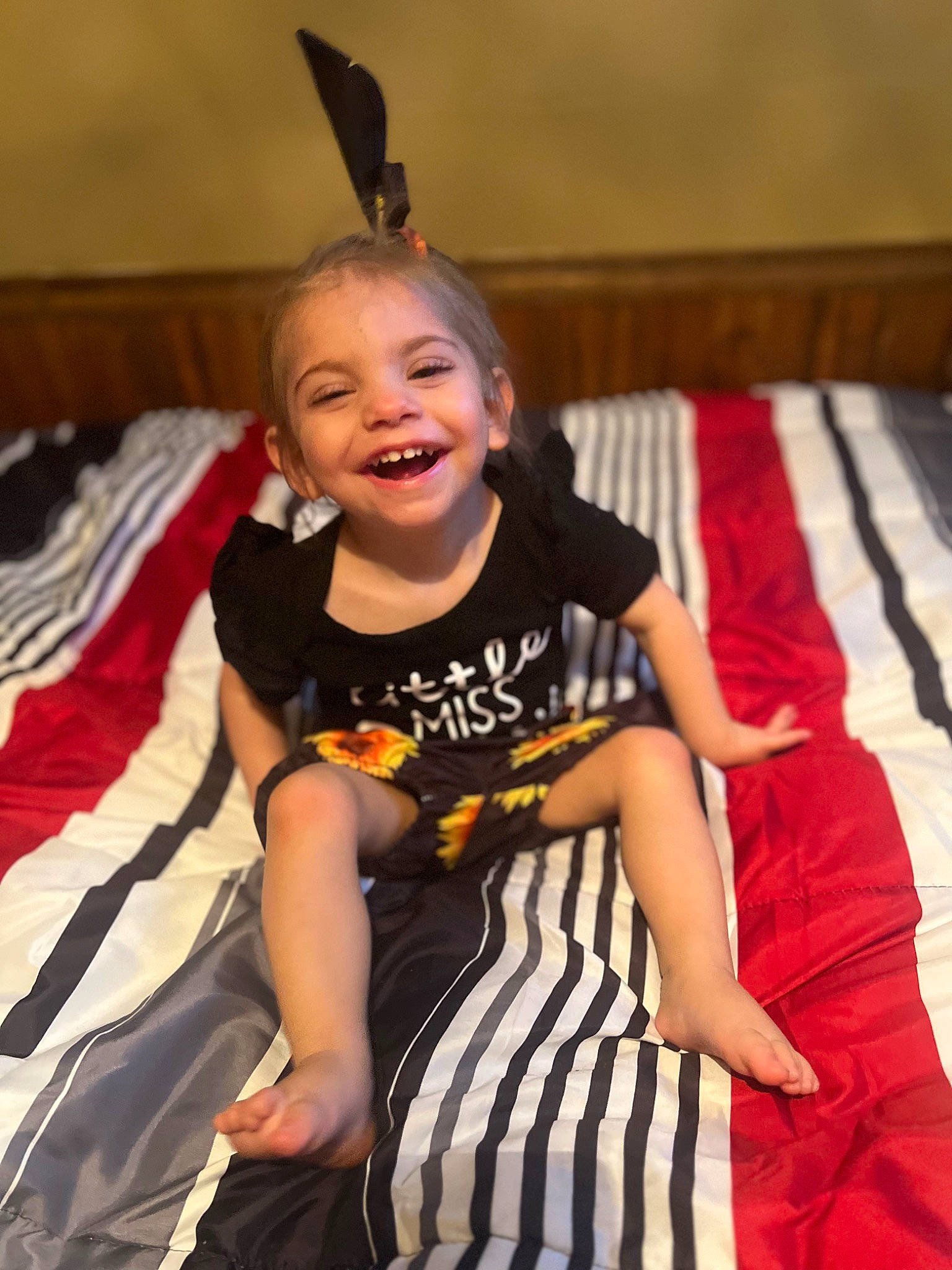 Kaykay is registered to the contest to win money with this photo: child, event, eye, fashion_design, flooring, fun, happy, joy, laugh, leisure, linens, mammal, person, room, sitting, sleeve, smile, t_shirt, thigh, toddler