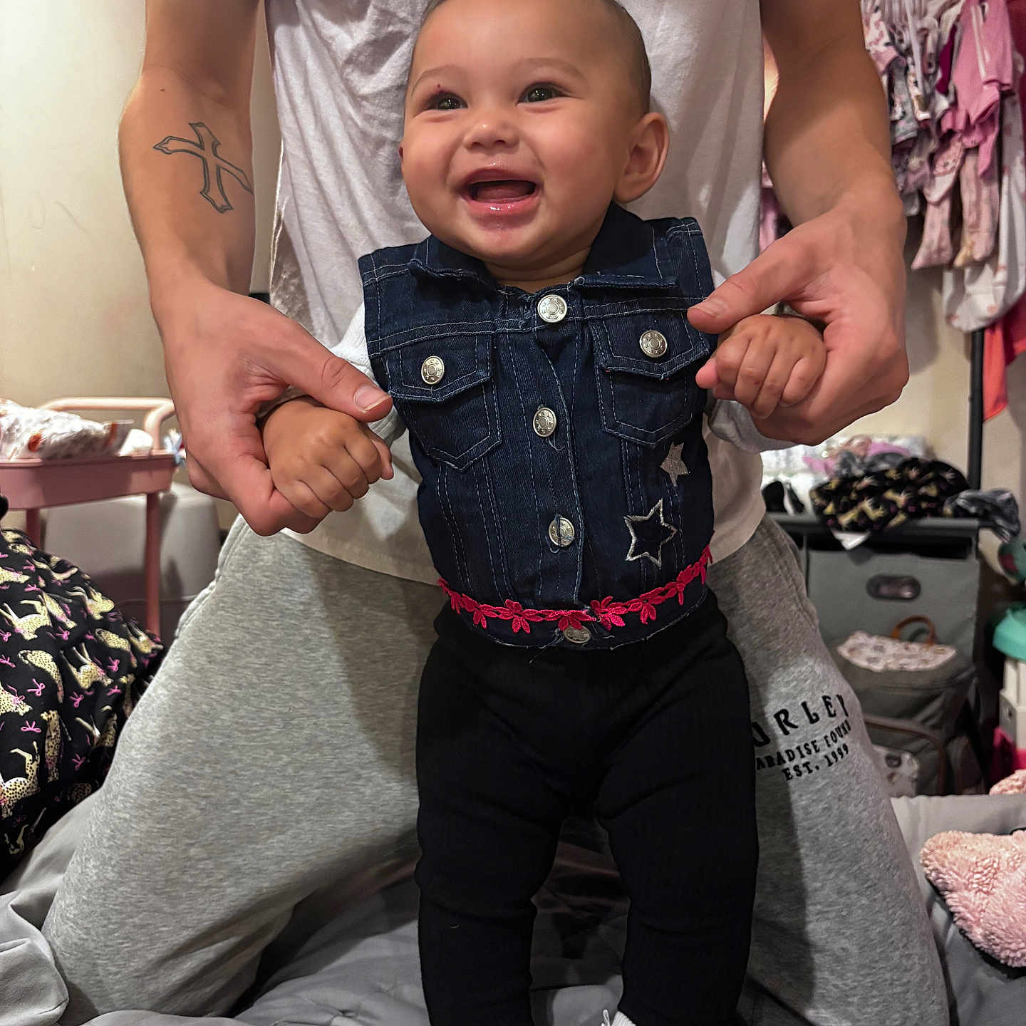 Zariya joined the competition — help win amazing prizes! baby, child, smiling, happy, portrait, indoor, bedroom, adult, parent, holding, denim, outfit, black_pants, white_socks, clothing, wardrobe, bed, home, tattoo, family