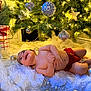Jordan joined the competition — help win amazing prizes! baby, christmas_tree, ornament, red_shorts, holiday, lights, smiling, decorations, fluffy_blanket, indoors, festive, joyful, infant, happy, holiday_decor, pine_tree, celebration, sparkle, cozy, cute