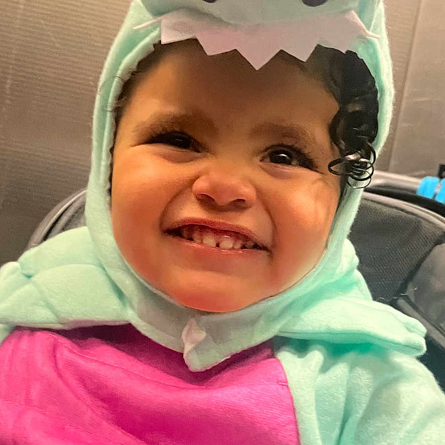 Cateleya is registered to the contest to win money with this photo: baby, bodypart, bonnet, cap, clothing, face, finger, hand, happy, hat, head, hood, hoodie, knitwear, person, photography, portrait, smile, sweater, sweatshirt