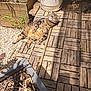 cat, tabby, sunlight, wooden_deck, outdoor, plant_pot, relaxed, pet, animal, sunny, garden, shadows, striped_fur, nature, daylight, feline, resting, peaceful, summer, home_garden