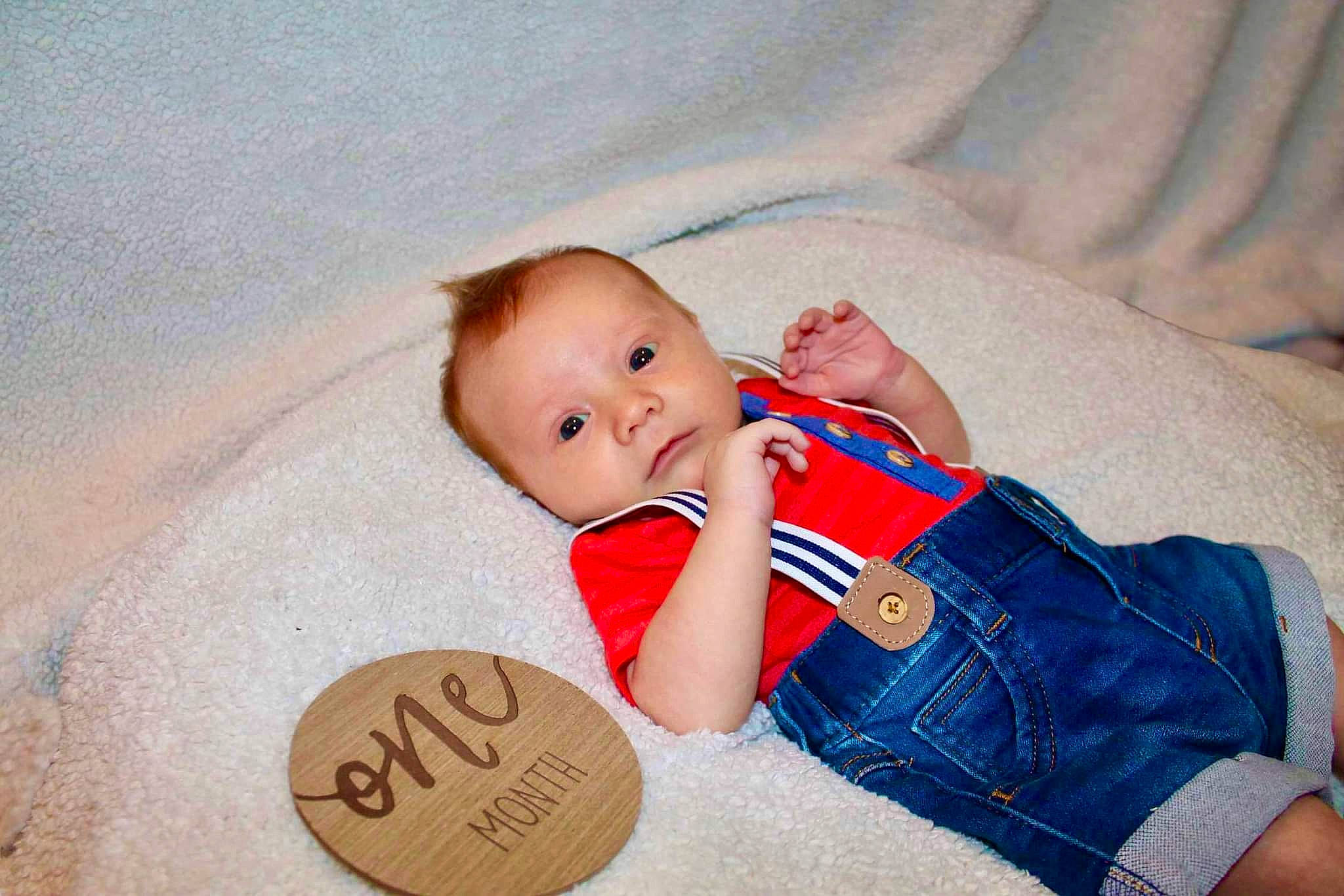 Jamie is registered to the contest to win money with this photo: baby, baby_products, baby_safety, baby_sleeping, baby_toddler_clothing, cheek, child, comfort, foot, hand, happy, linens, pattern, person, room, sitting, skin, sleeve, textile, toddler