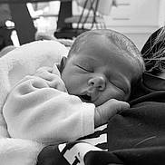 Basile participe au concours pour gagner de l'argent avec cette photo : baby, black_and_white, blanket, closeup, clothing, cozy, cute, face, hand, indoors, infant, monochrome, newborn, peaceful, person, portrait, resting, sleeping, soft, toddler