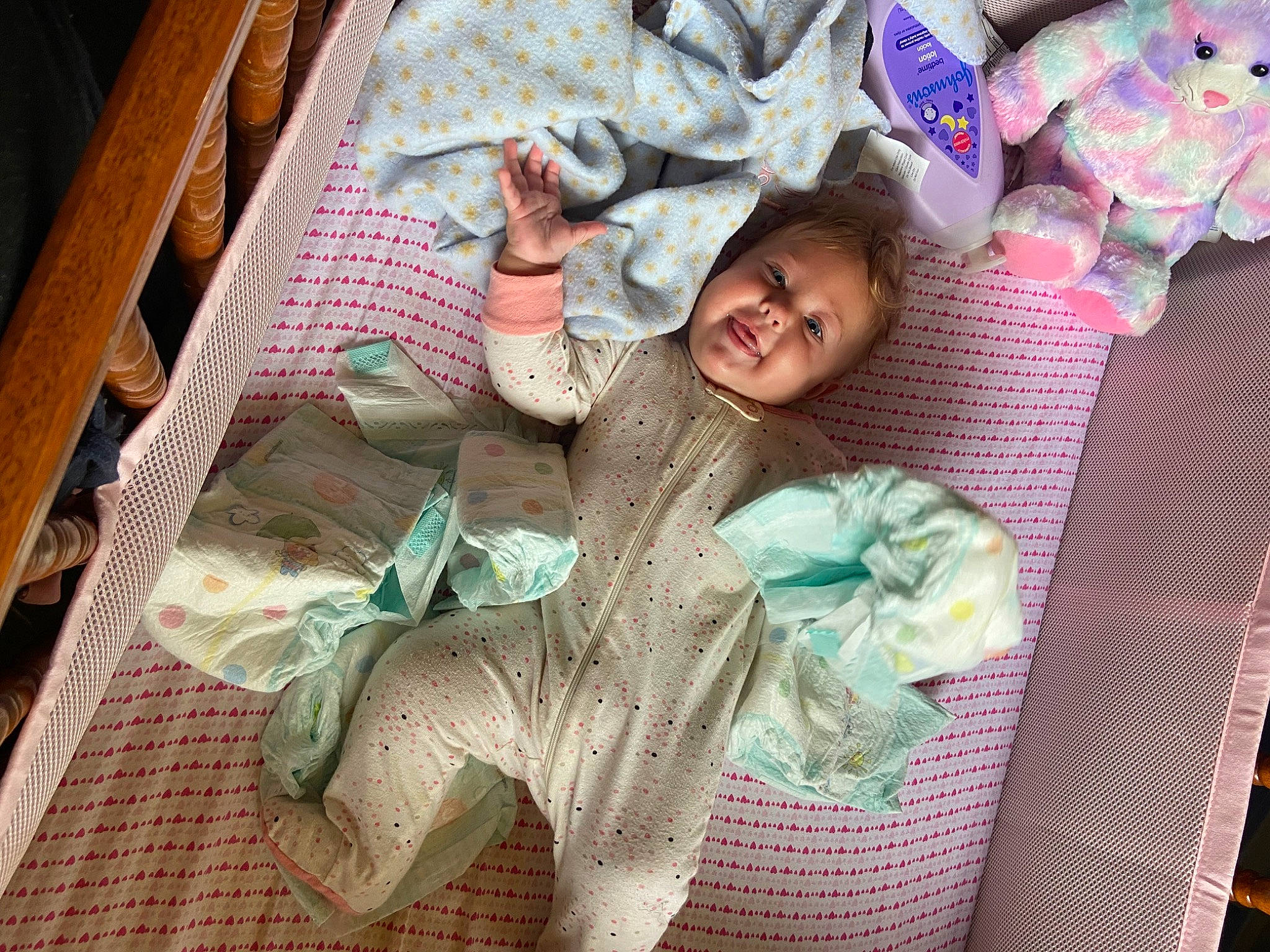 Kathryn is registered to the contest to win money with this photo: baby, baby_products, bedding, blanket, child, comfort, fun, happy, linens, pattern, person, pink, plastic, room, sitting, smile, textile, toddler, wood, wool