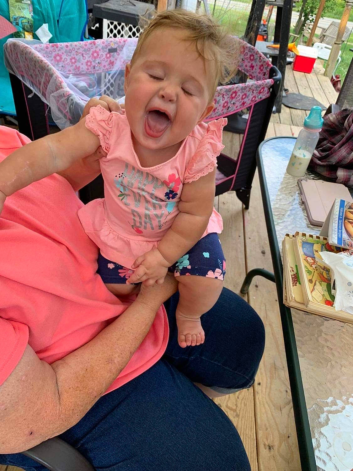 Kathryn joined the competition — help win amazing prizes! baby, baby_toddler_clothing, chair, child, event, foot, fun, grass, happy, human_leg, lap, leisure, person, pink, recreation, sandal, shorts, sitting, t_shirt, thigh