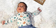 Isaac joined the competition — help win amazing prizes! baby, blue_shorts, child, curious_expression, cute, decor, dinosaur_pajamas, fluffy_rug, indoors, infant, lying_down, milestone, months_marker, newborn, portrait, small_hands, socks, soft_texture, white_background, wooden_blocks