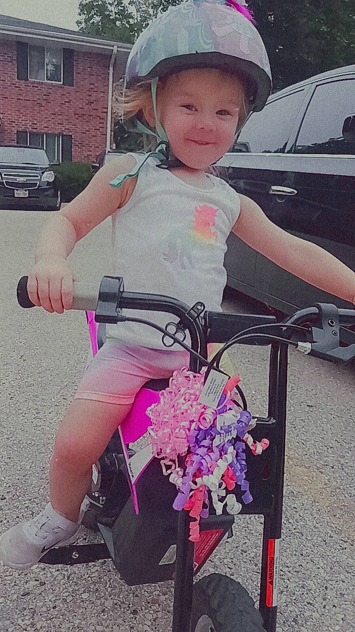 Serenity is registered to the contest to win money with this photo: baby_carriage, bicycle, bicycle_accessory, bicycle_frame, bicycle_handlebar, bicycle_helmet, bicycle_part, bicycle_tire, bicycle_wheel, bicycles_equipment_and_supplies, car, headwear, helmet, joy, motor_vehicle, person, photograph, pink, smile, tire