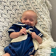 Easten is registered to the contest to win money with this photo: baby, bed, blanket, bodypart, clothing, cushion, face, finger, furniture, hand, head, homedecor, newborn, person, photography, portrait, quilt, shorts, sitting, sleeping